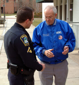 Policeman talks to elderly man